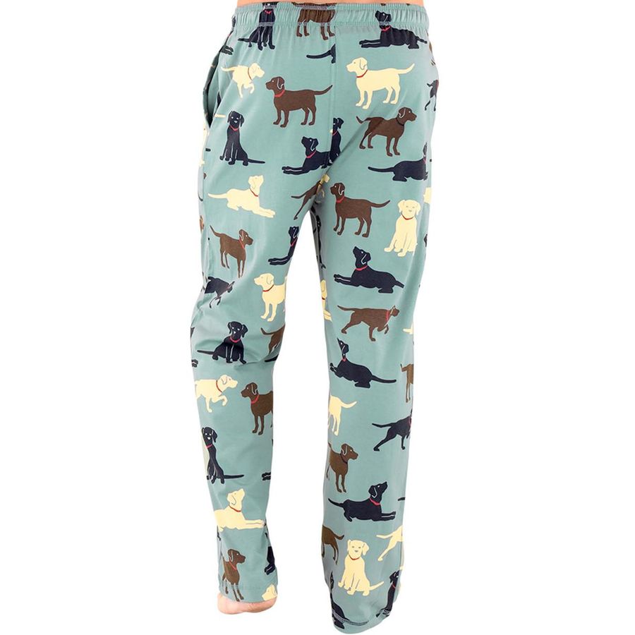 A pair of lounge pants in a dusty mint green color, featuring an all-over print of cartoon dog illustrations in black, brown, and cream. The pants have an elastic waistband and are shown against a plain white background.