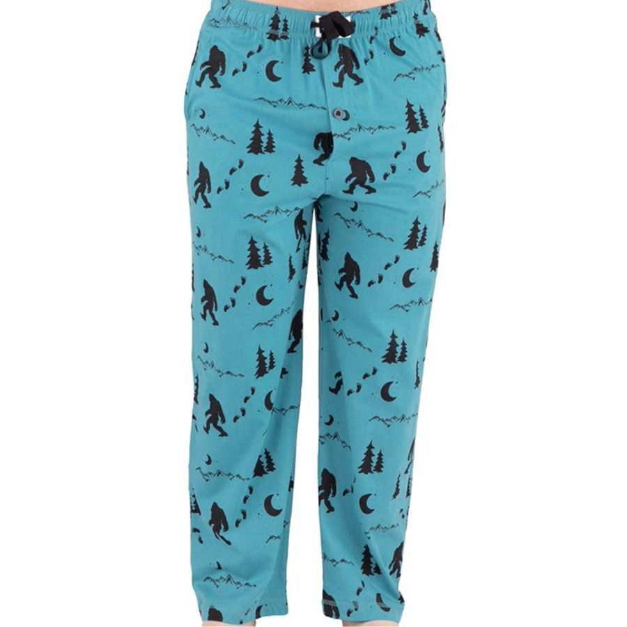 A pair of women's lounge pants in turquoise blue with a black allover print of Bigfoot, trees, and moons, shown on a white background.