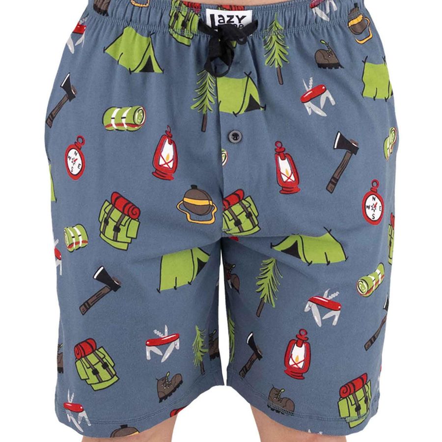 A pair of men's shorts featuring a blue-gray base color with a colorful camping-themed print of green tents, red lanterns, brown axes, and other outdoor gear, shown on a model against a white background.
