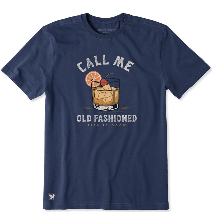 A navy blue short-sleeve t-shirt with a vintage-style graphic of an iced cocktail with an orange slice and cherry, accompanied by the text 'CALL ME OLD FASHIONED' and 'LIFE IS GOOD'.