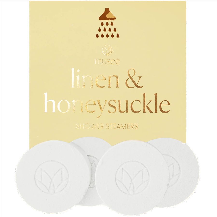 Pack of shower steamers labeled 'linen & honeysuckle' with a brand logo on a beige background.