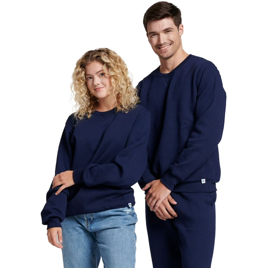 Two people wearing navy blue sweatshirts and jeans on a white background