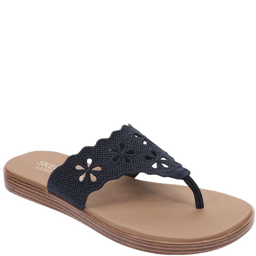 Navy sandal with floral design on a beige sole against a white background
