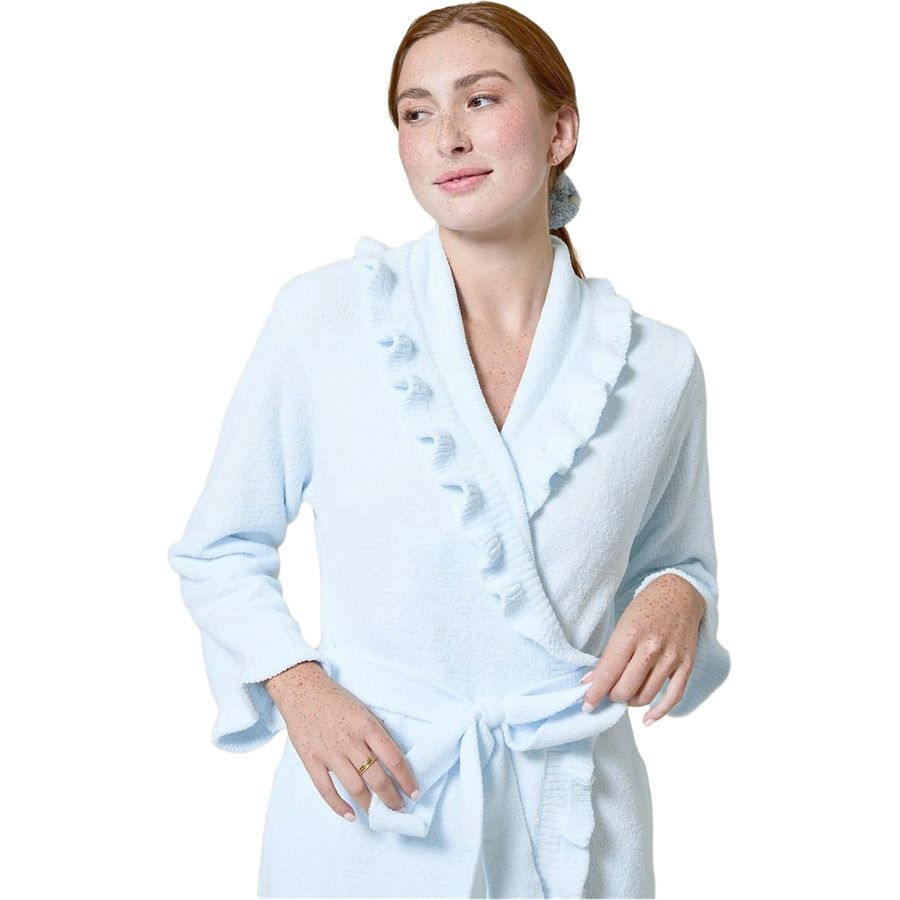 A woman wearing a light blue terry cloth bathrobe with ruffled trim and a tie waist, photographed against a plain white background.