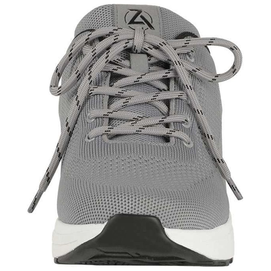 Gray athletic shoe with black sole on a white background