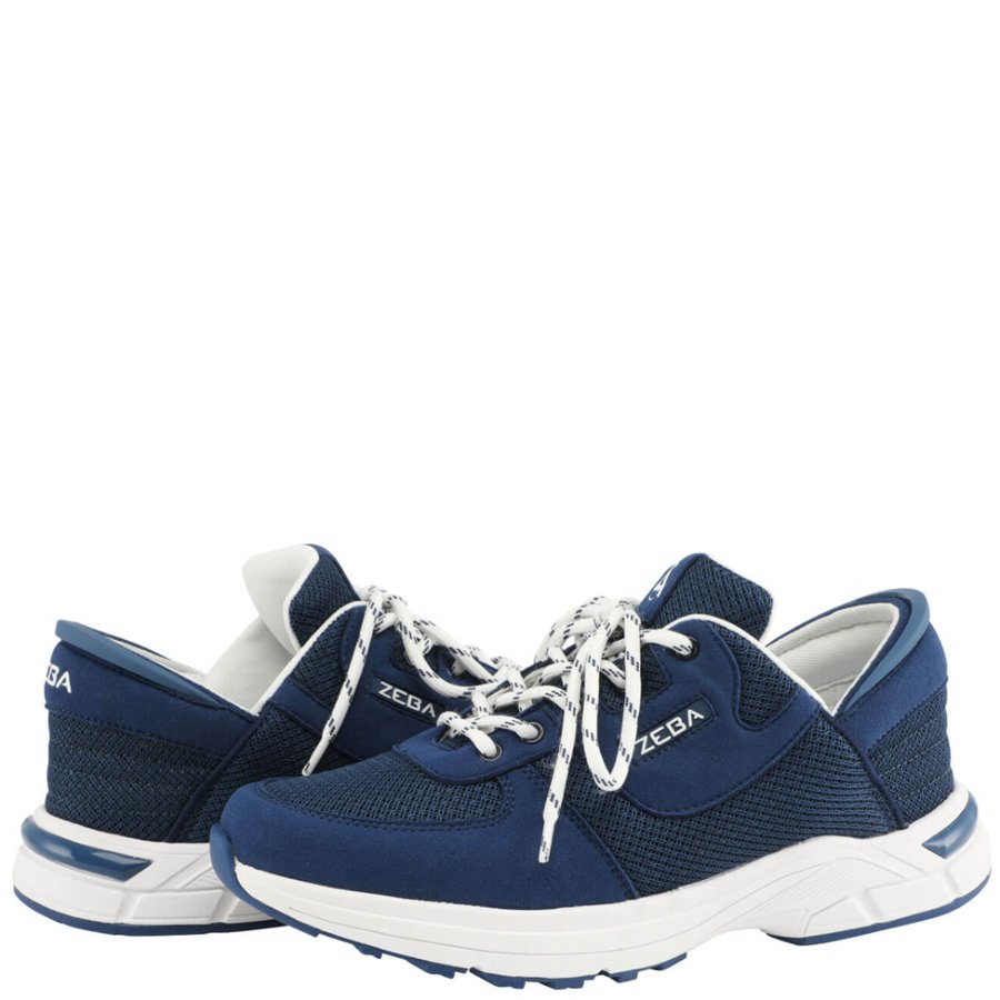 Pair of blue athletic shoes with white laces on a white background