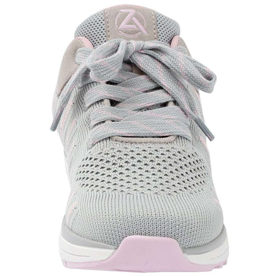 Light gray athletic shoe with pink accents on a white background