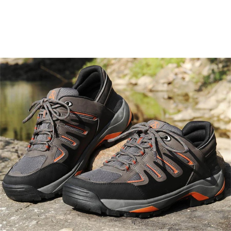 Pair of gray and black hiking shoes with orange accents on a natural background.